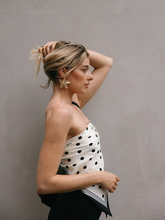 a lady wears the polka dots printed silk scarf as a tube top